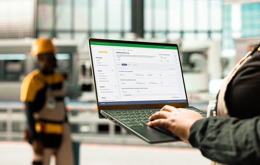 Bray International Interview, Mockup, Mitarbeiterin hält Laptop mit leadity Software in Maschinenbauhalle