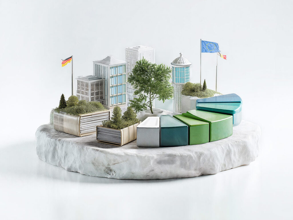 3D Welt auf einem runden weißen Sockel, Teile eines Tortendiagramms, dicke Gesetzbücher mit Grünzeug bewachsen, Regierungsgebäude, Flaggenmasten mit EU-Flagge, Belgienflagge und Deutschlandflagge, ein Baum in der Mitte
